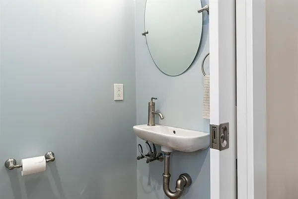 a bathroom with a sink a mirror and a toilet