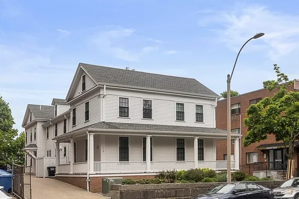 a front view of a residential apartment building with a yard