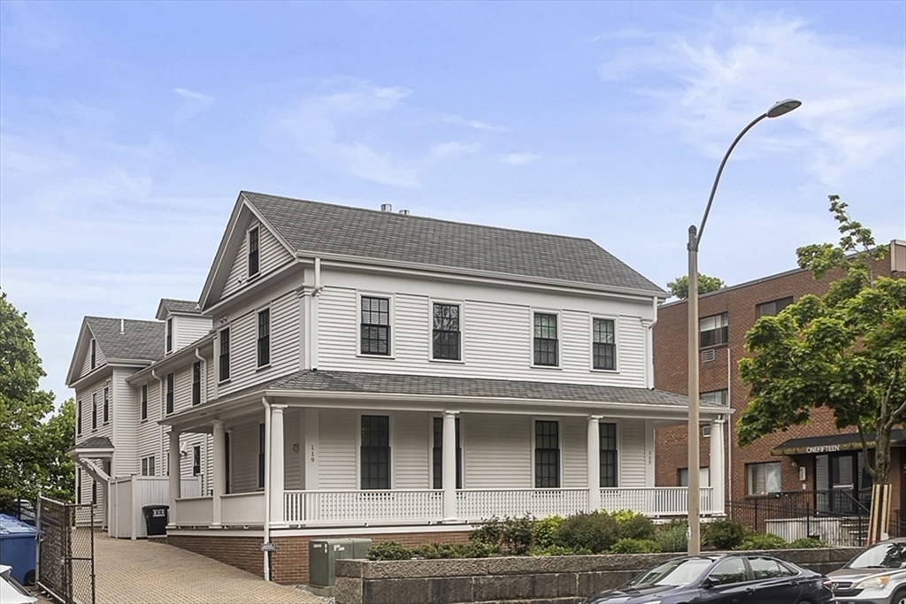 119 Highland Avenue, Unit B Somerville, MA 02143 - Photo 19 of 24 a front view of a residential apartment building with a yard