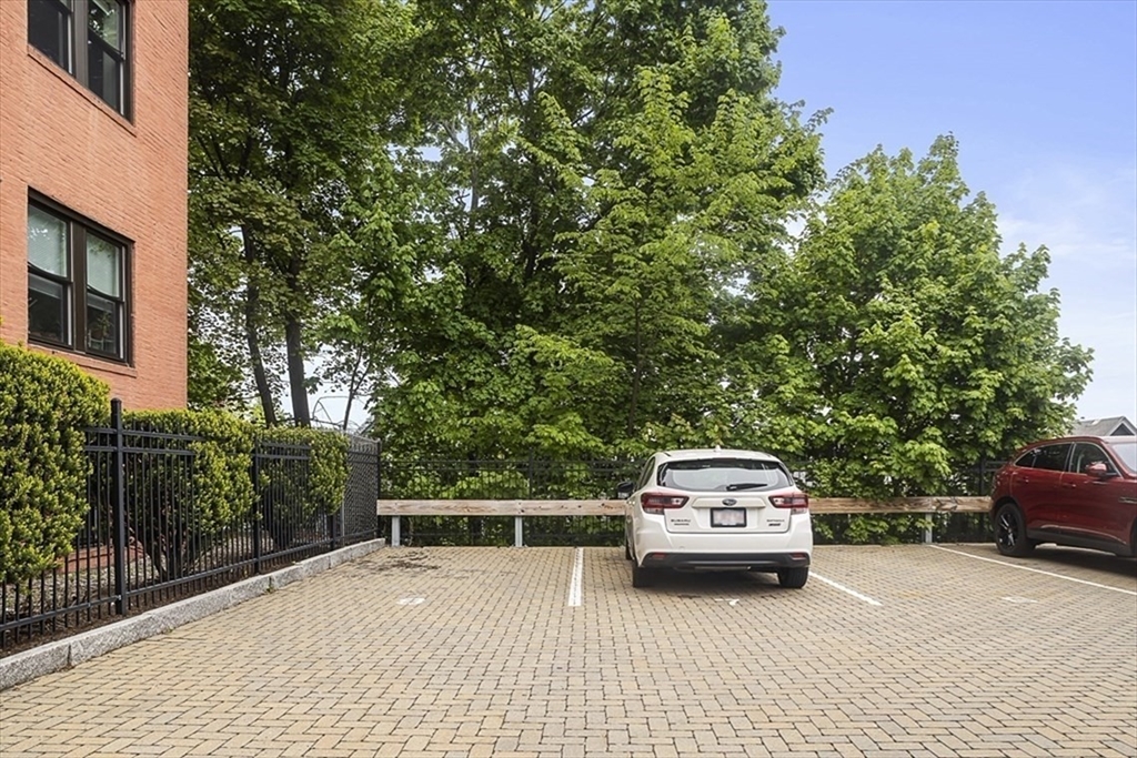 119 Highland Avenue, Unit B Somerville, MA 02143 - Photo 21 of 24 a car parked in front of a house