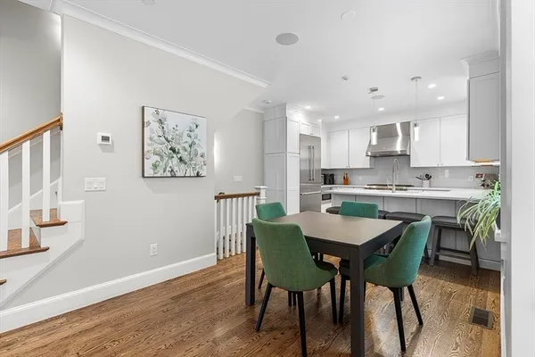 a view of a dining room with furniture and wooden floor