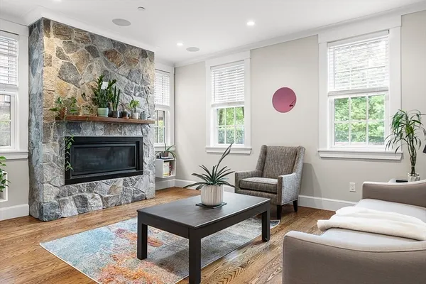 a living room with furniture a flat screen tv and a fireplace