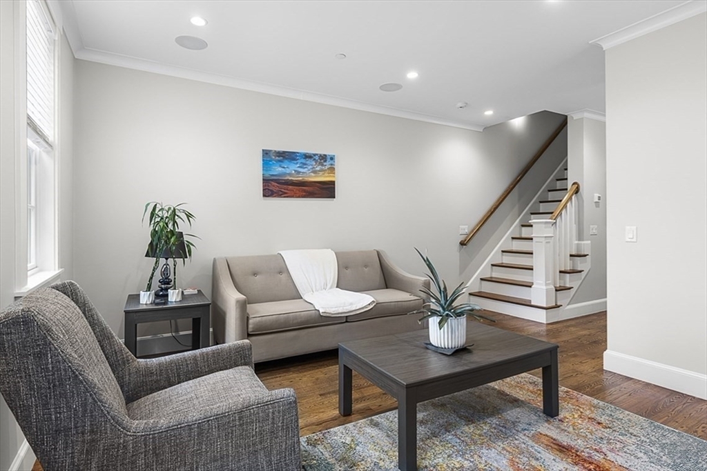 119 Highland Avenue, Unit B Somerville, MA 02143 - Photo 7 of 24 a living room with furniture potted plant and wooden floor