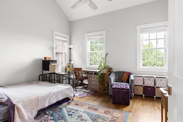 a bedroom with a bed and wooden floor