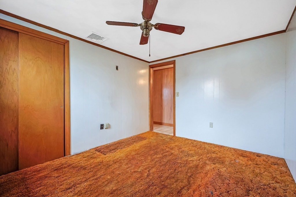 261 Adelaide Street Fall River, MA 02721 - Photo 17 of 28 a view of a room with a ceiling fan and wooden floor