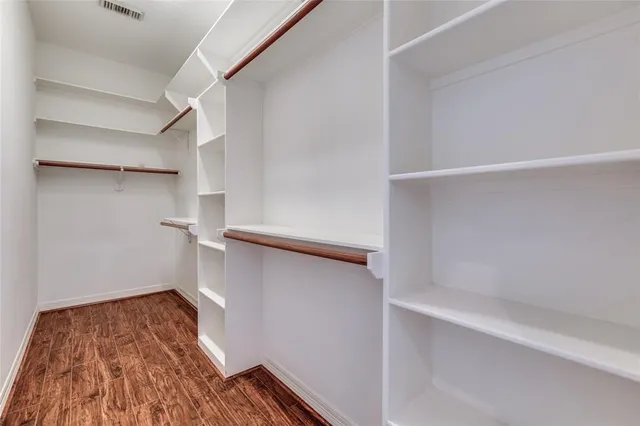 a view of entryway and hall with a chandelier fan