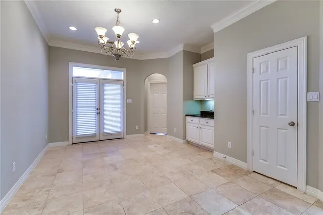 a view of a chandelier in a room with windows and chandelier