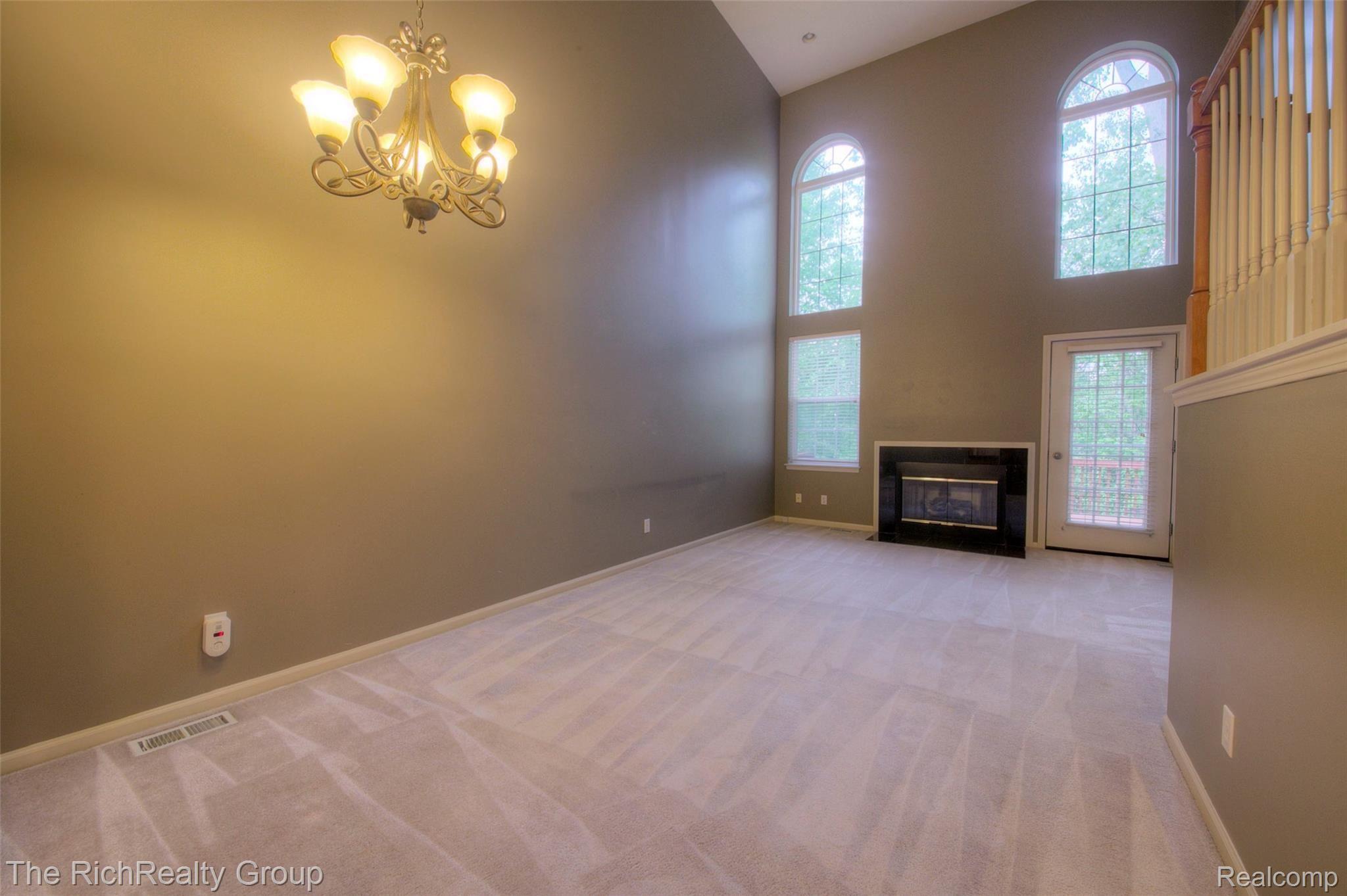 41796 Glade Road, Unit 43 Canton, MI 48187 - Photo 8 of 35 2-story great room has gas fireplace and windows getting afternoon sun