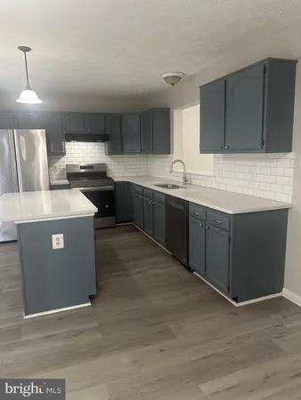 a view of a room with wooden floor and white walls