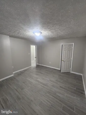 a view of an empty room and wooden floor