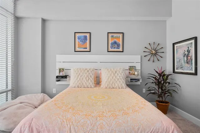 a bedroom with a bed and a television