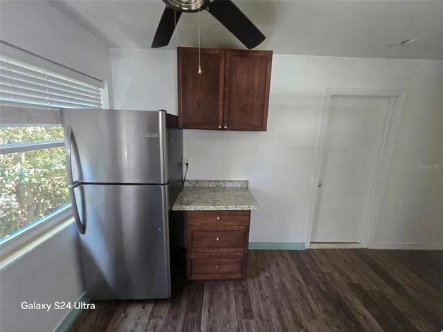 a kitchen with a refrigerator and a stove top oven