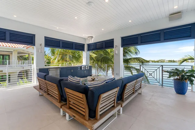 a front view of a house with swimming pool and sitting area