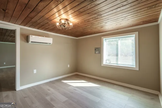 a view of an empty room with wooden floor