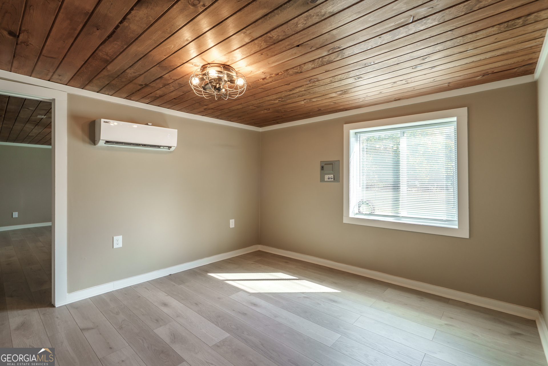 1121 Prospect Road, Unit A Madison, GA 30650 - Photo 11 of 34 an empty room with wooden floor and windows