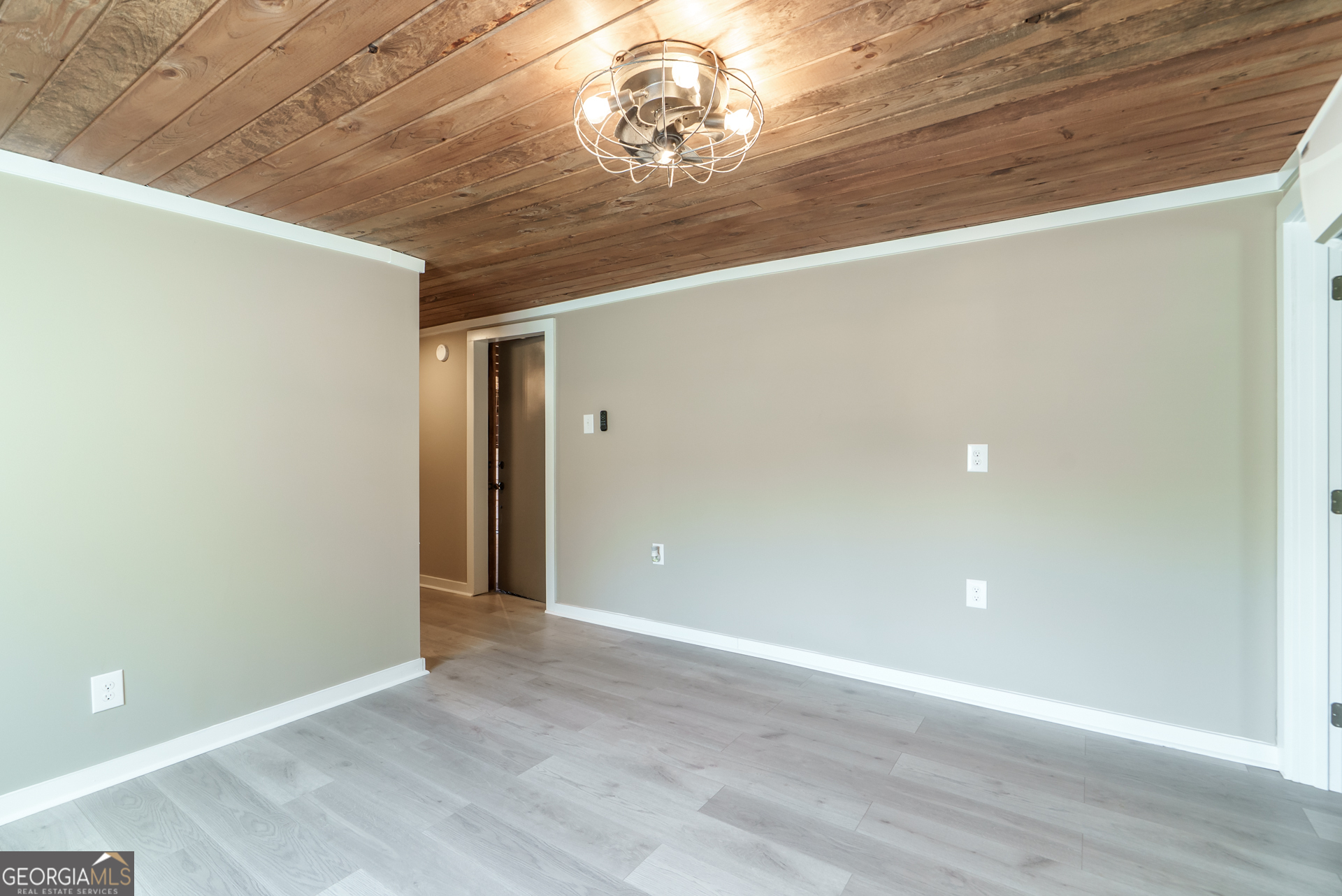 1121 Prospect Road, Unit A Madison, GA 30650 - Photo 12 of 34 a view of an empty room with wooden floor