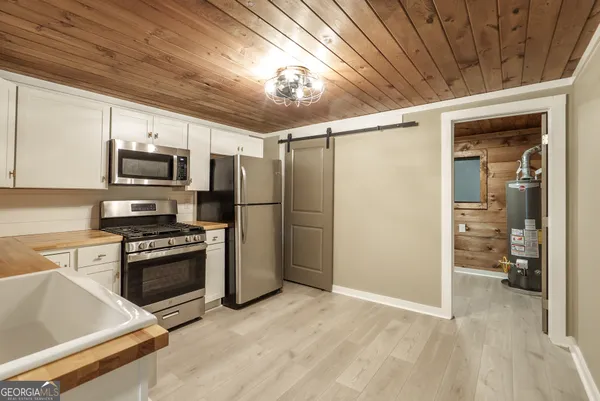 a kitchen with stainless steel appliances granite countertop a stove sink and refrigerator