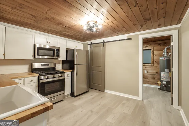 a kitchen with stainless steel appliances granite countertop a stove sink and refrigerator
