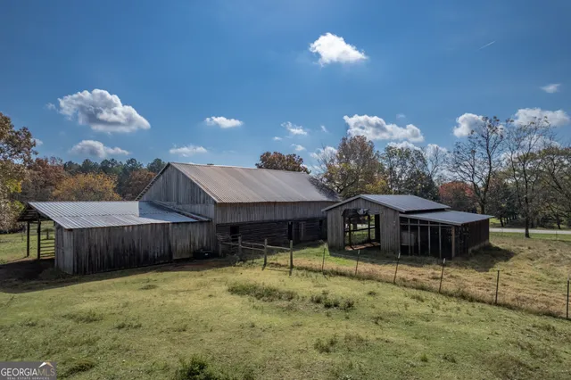 a view of a house with a yard and sitting area