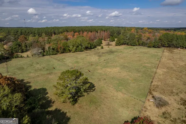 an aerial view of a house with a yard
