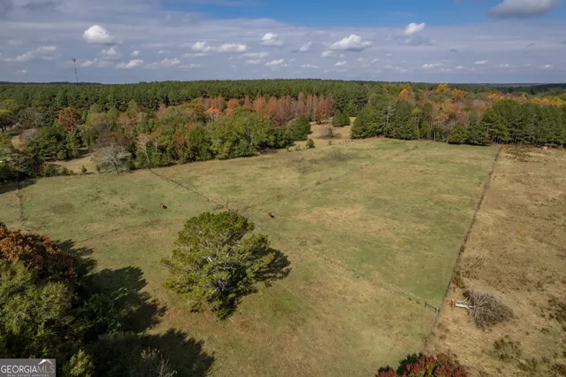 an aerial view of a house with a yard