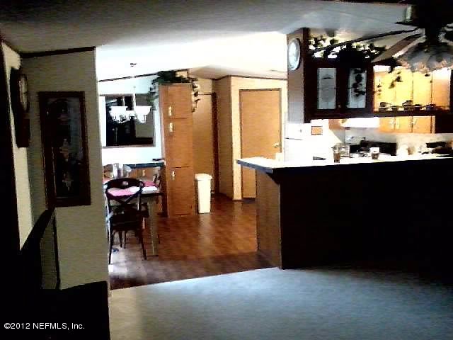 5291 Collins Road, Unit 269 Jacksonville, FL 32244 - Photo 6 of 12 Living Room Looking into Kitchen