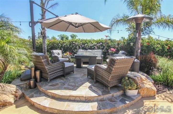 14747 Dash Way Poway, CA 92064 - Photo 12 of 23 a view of a patio with couches table and chairs under an umbrella