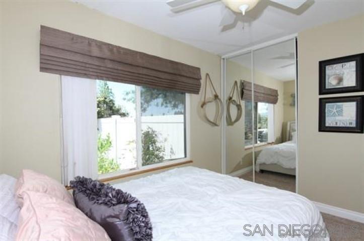 14747 Dash Way Poway, CA 92064 - Photo 13 of 23 a bedroom with a bed mirror and window