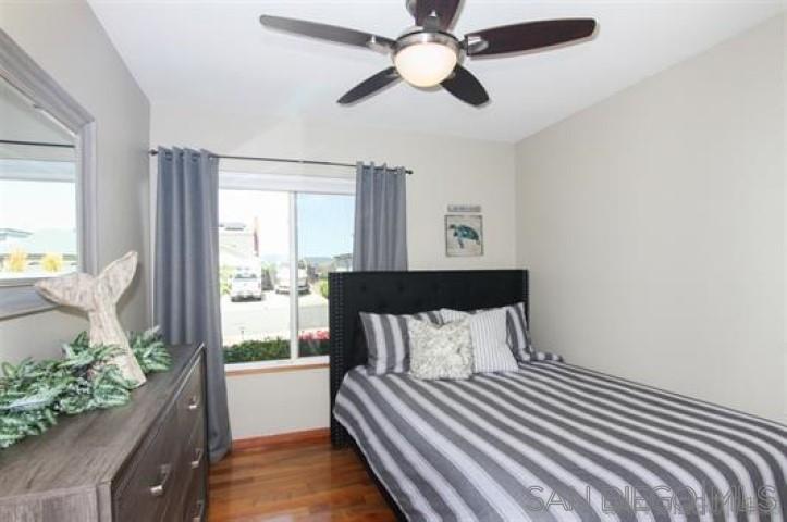 14747 Dash Way Poway, CA 92064 - Photo 15 of 23 a bedroom with a bed and wooden floor