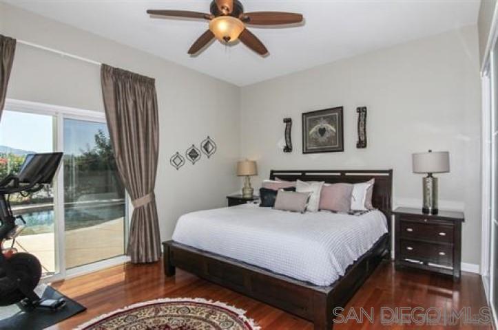 14747 Dash Way Poway, CA 92064 - Photo 16 of 23 a bedroom with bed and wooden floor