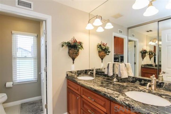 14747 Dash Way Poway, CA 92064 - Photo 17 of 23 a bathroom with a granite countertop sink and a mirror