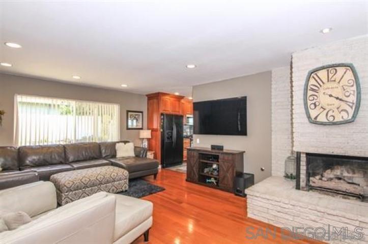 14747 Dash Way Poway, CA 92064 - Photo 7 of 23 a living room with furniture a flat screen tv and a fireplace