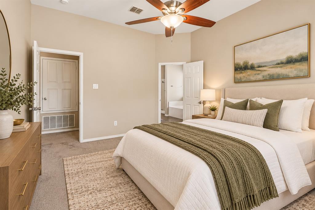 101 Ravinia Court Oak Point, TX 75068 - Photo 11 of 23 Vaulted ceiling with a wood-finish ceiling fan, upholstered headboard, and beige carpeting