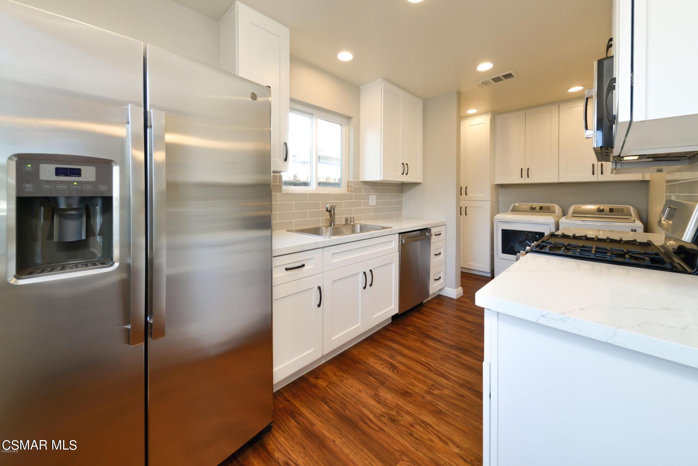 2769 Los Robles Road Thousand Oaks, CA 91362 - Photo 3 of 15 a kitchen with a sink a stove cabinets and a refrigerator