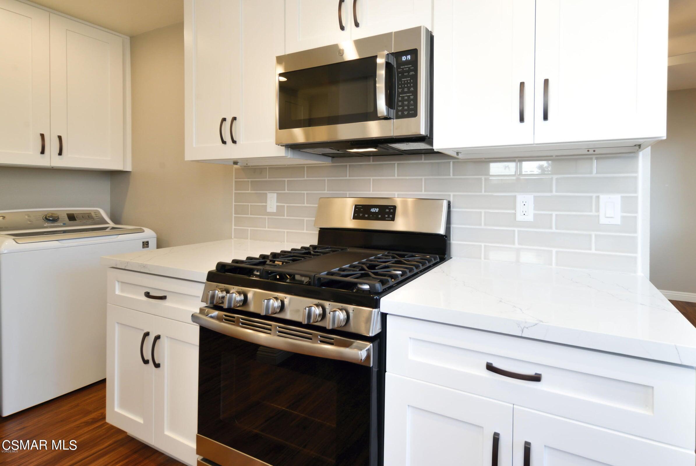 2769 Los Robles Road Thousand Oaks, CA 91362 - Photo 8 of 15 a kitchen with stainless steel appliances white cabinets and a stove a oven with white countertops