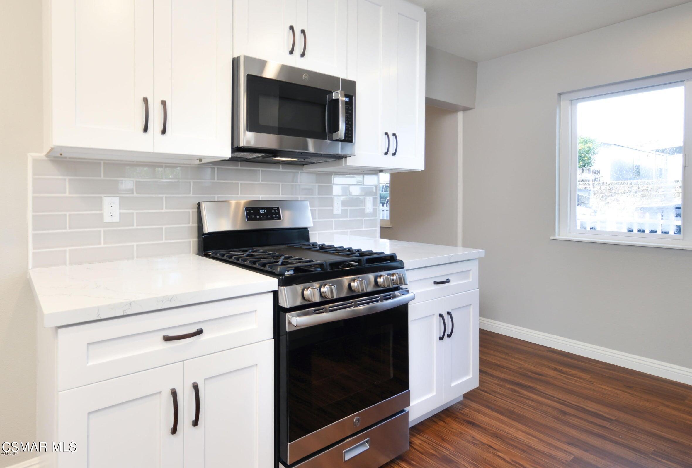 2769 Los Robles Road Thousand Oaks, CA 91362 - Photo 9 of 15 a kitchen with stainless steel appliances white cabinets and a stove top oven