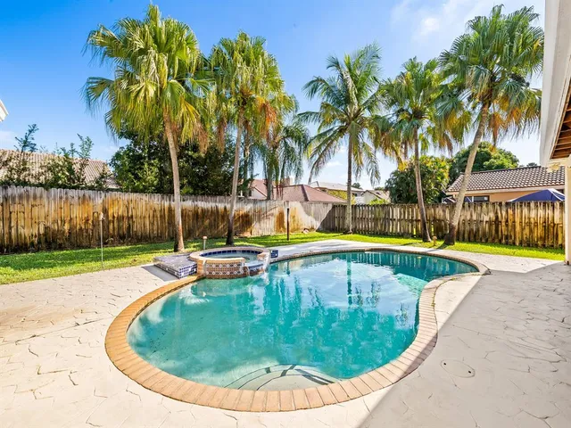 a view of a house with a swimming pool and a chairs