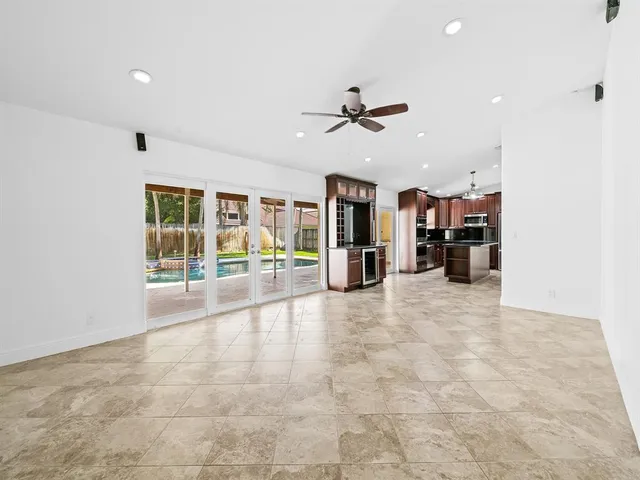 a view of empty room with wooden floor and windows