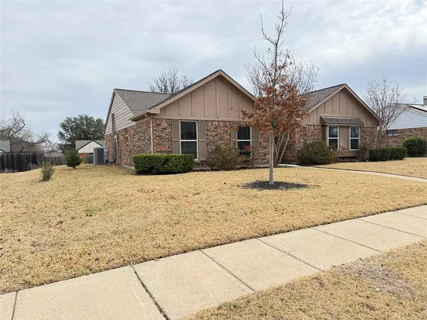 a front view of a house with a yard covered in snow