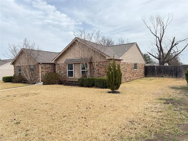 a front view of a house with a yard covered in snow