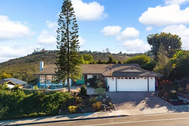 a front view of a house with a yard and fountain