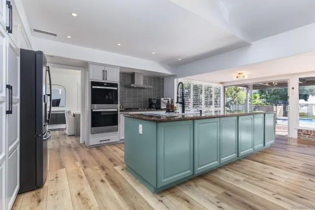 a kitchen with a refrigerator and a sink