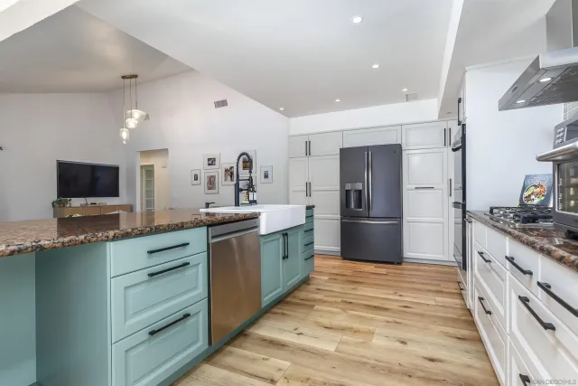 a kitchen with stainless steel appliances granite countertop a stove and a refrigerator
