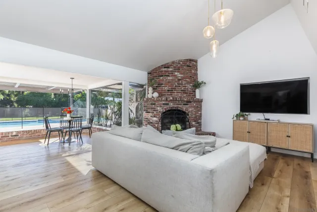 a living room with furniture a flat screen tv and a fireplace