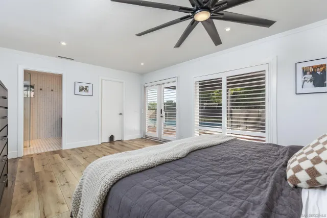 a bedroom with a large bed and a window