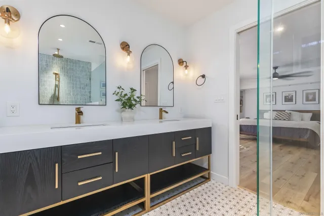a spacious bathroom with a double vanity sink and a mirror