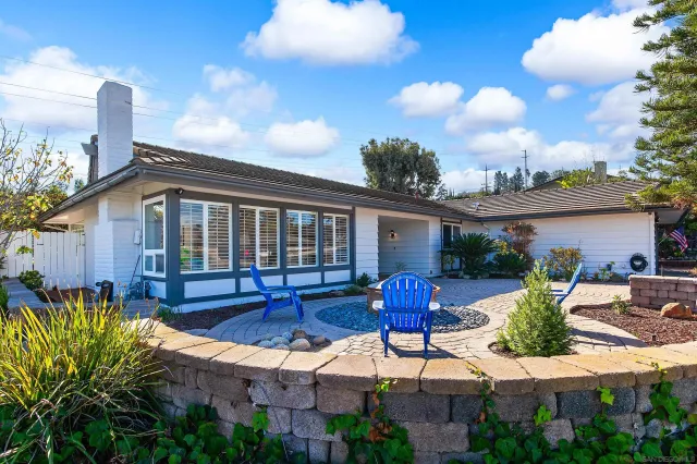 a front view of house with yard outdoor seating and green space