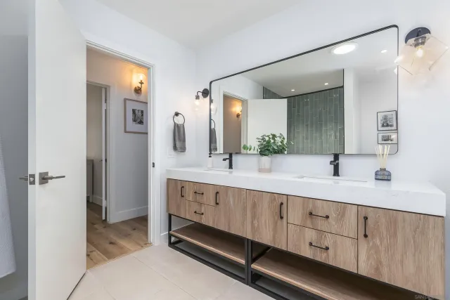 a bathroom with double sink and a mirror