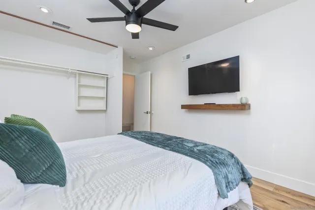 a bedroom with a bed and a flat screen tv