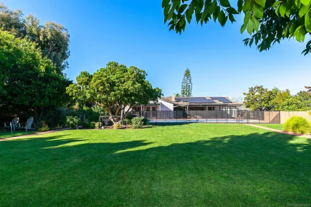a view of a garden with a house in the background